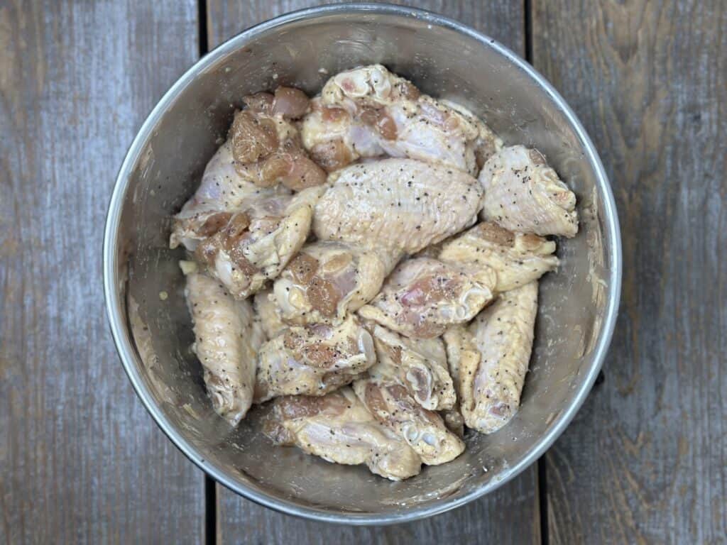 chicken wings seasoned in a bowl