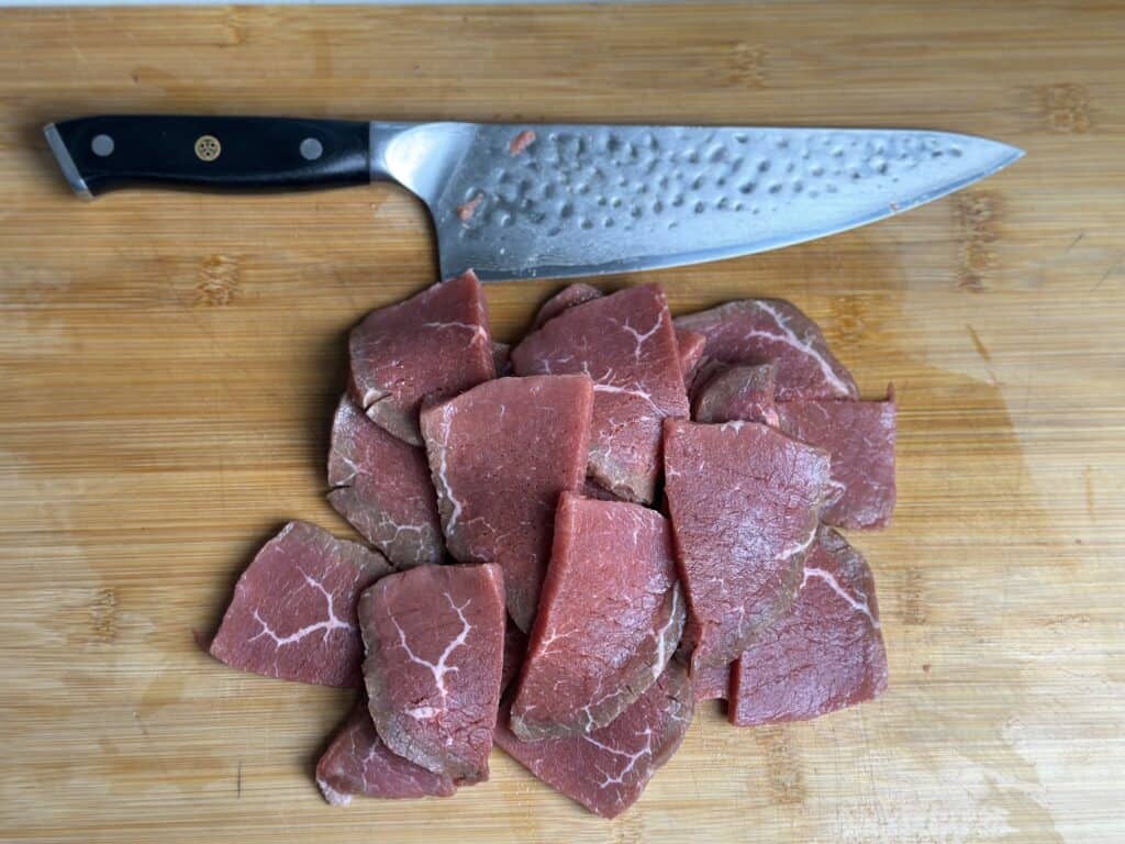 Eye of round roast cut into thin slices.