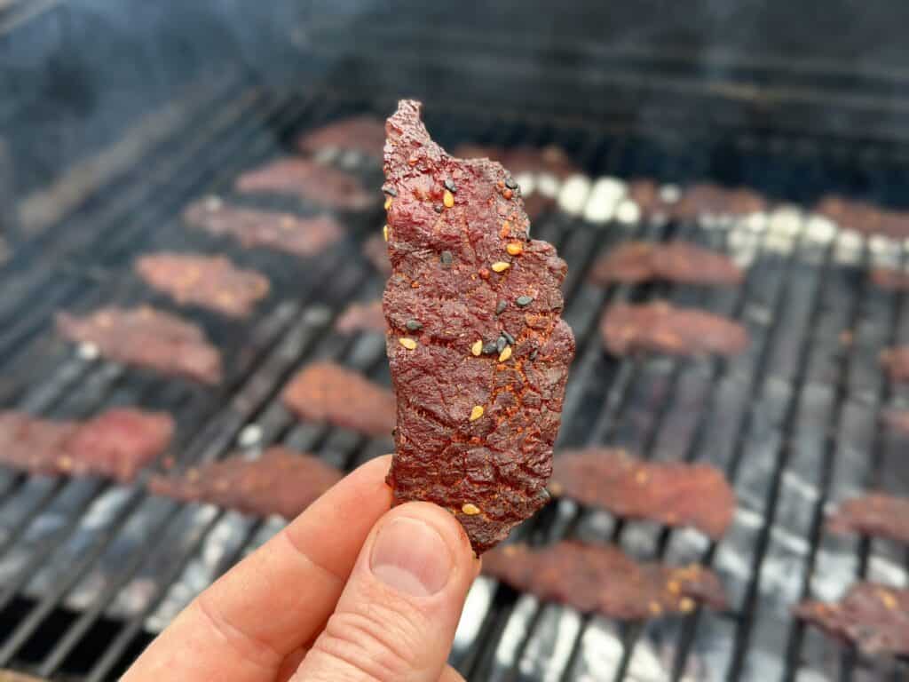 Beef jerky being smoked on a pellet grill.