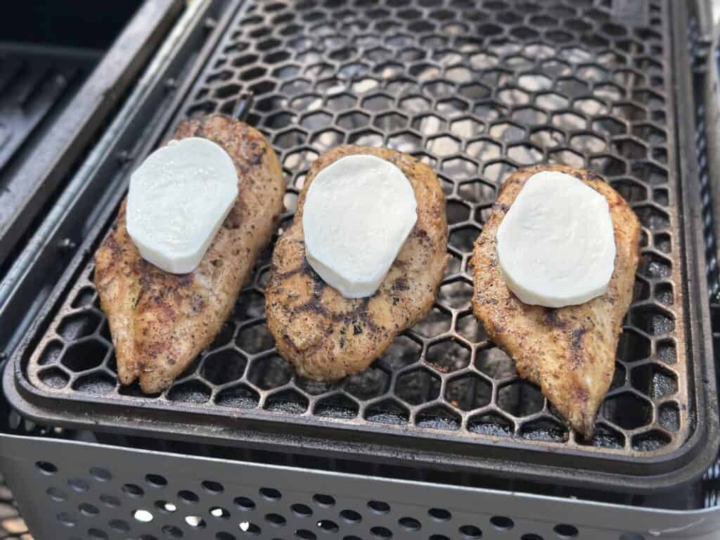 grilled chicken with fresh mozzarella on top.