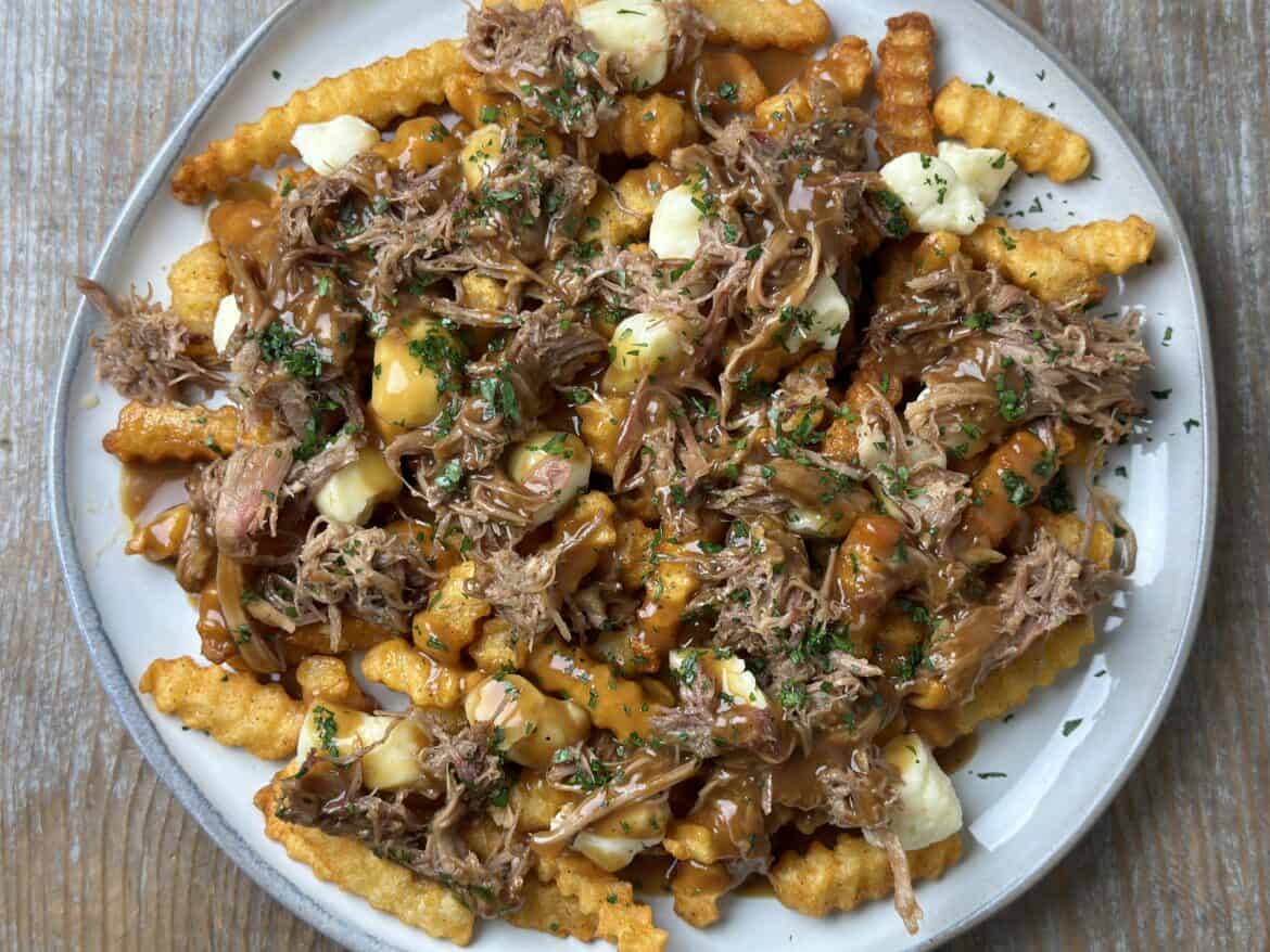 Smoked Pulled Pork Poutine on a plate.