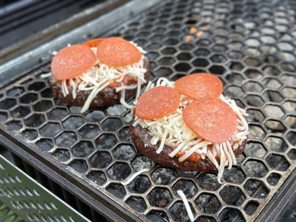 grilled pizza burger cooking on a grill