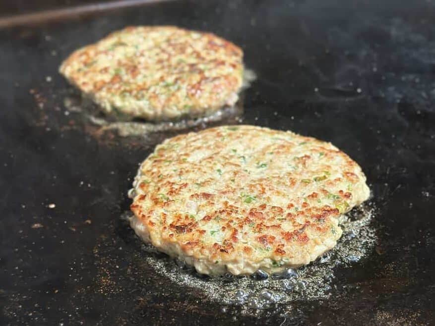 chicken bacon ranch burger cooking on a griddle