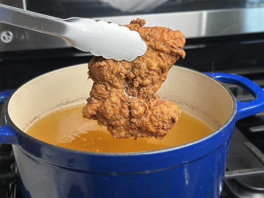 fired chicken being removed from hot oil