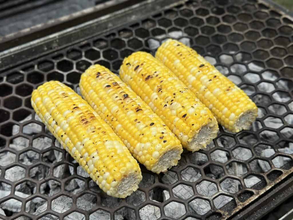 corn being grilled over charcoal