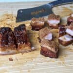 Cripsy pork belly burnt ends on a cutting board