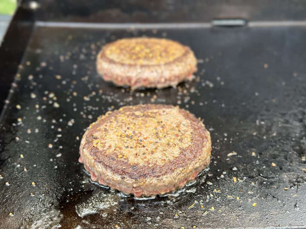 burger cooking on a griddle