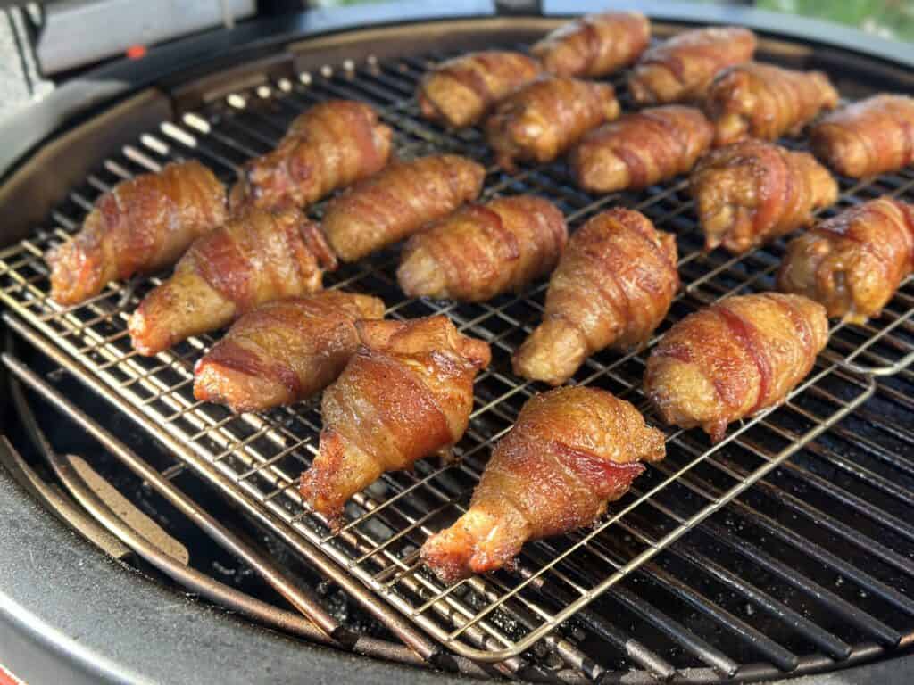 Smoked bacon wrapped chicken wings on the smoker