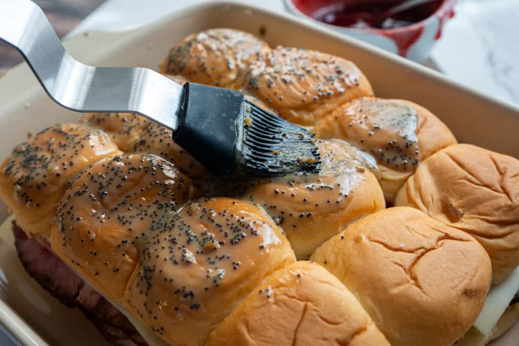 butter brushed on ham and cheese sliders