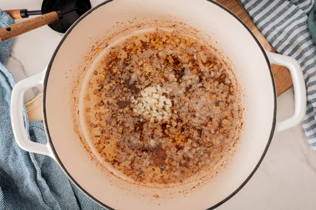 onions cooking in a dutch oven.