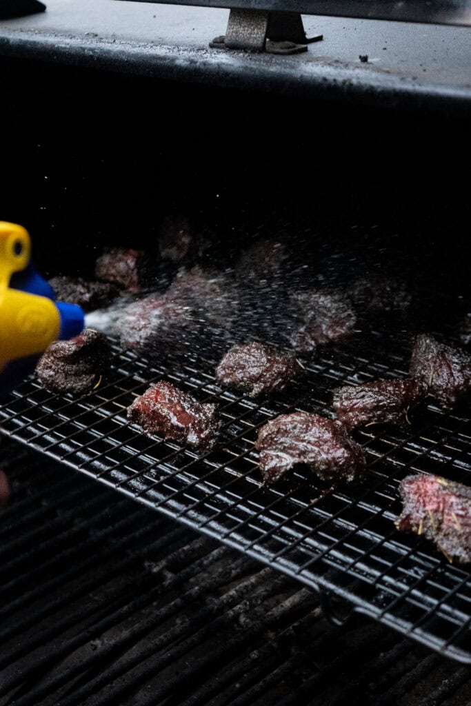 Chuck roast burnt ends being spritzed.