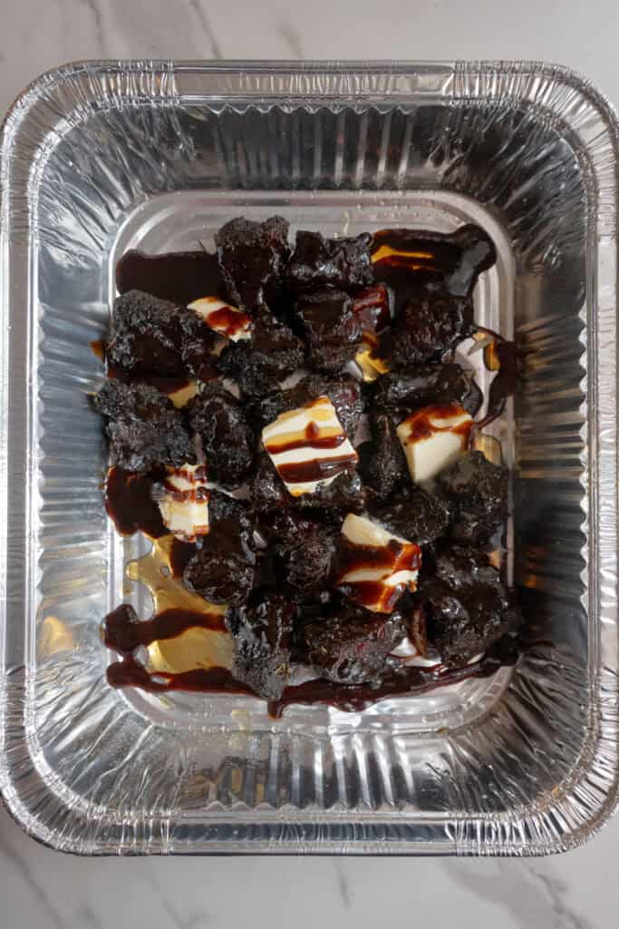 Chuck roast burnt ends coated in butter, brown sugar and sauce.