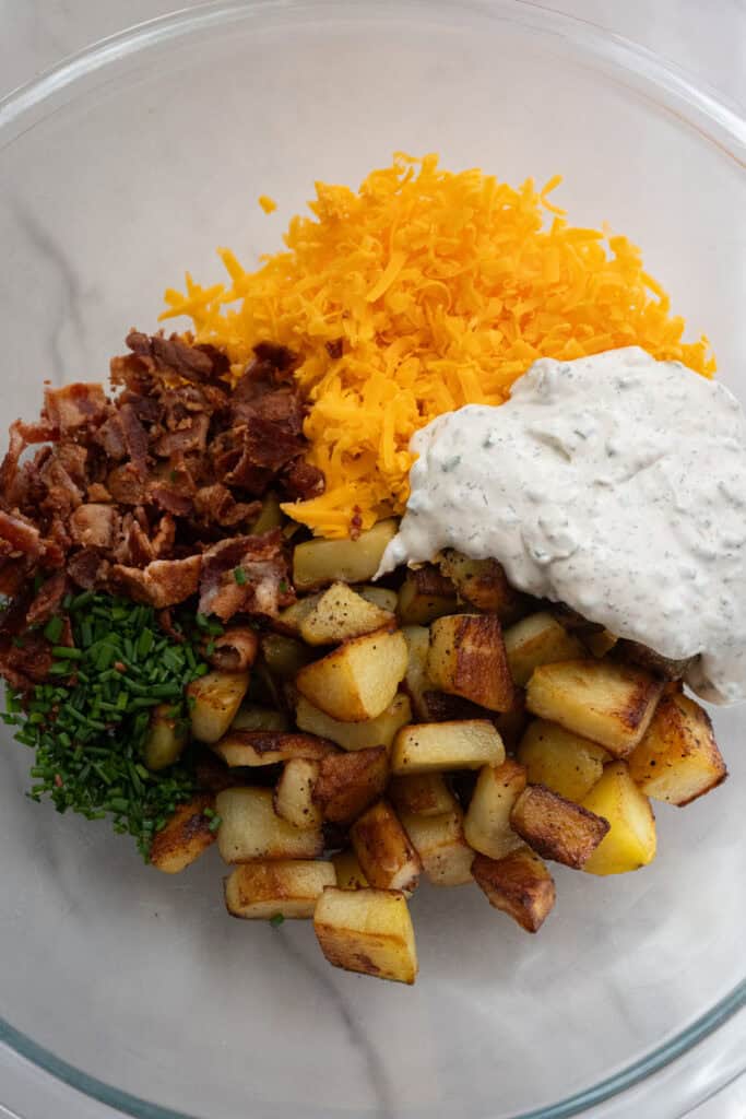 Bacon Ranch potato salad ingredients in a bowl.