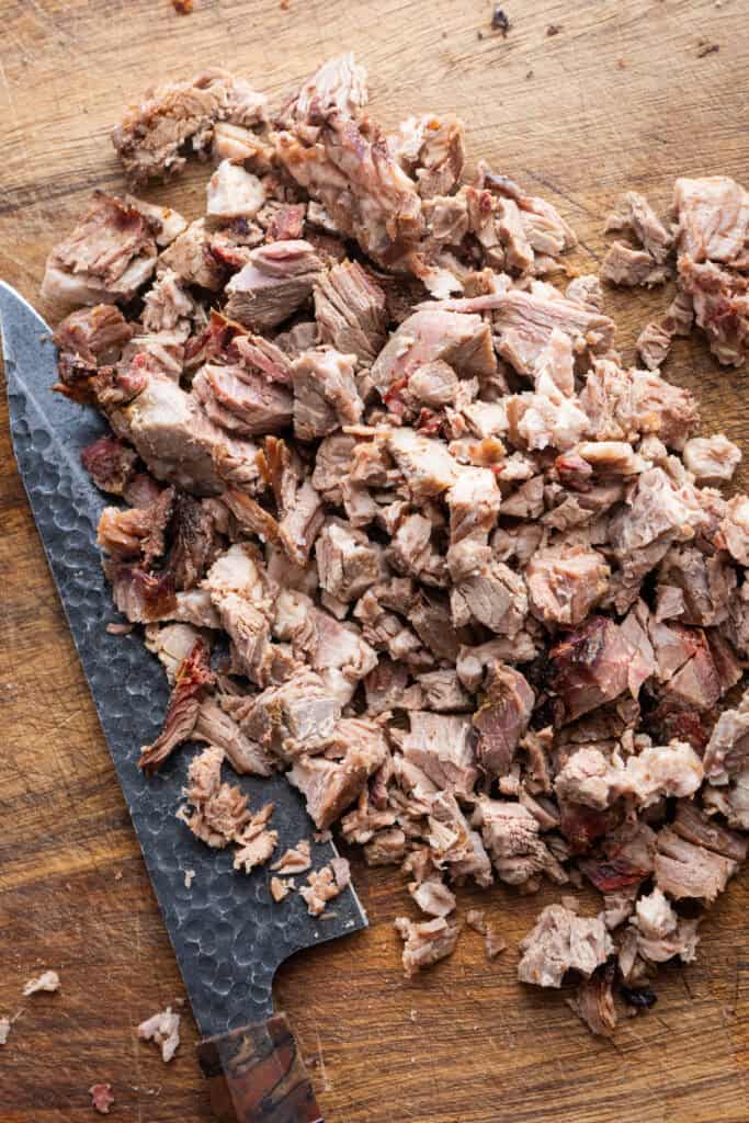 Brisket being chopped up with a knife.