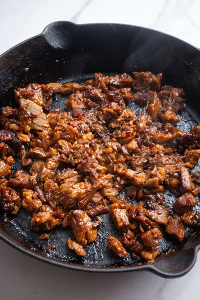 Chopped brisket with bbq sauce in a skillet.