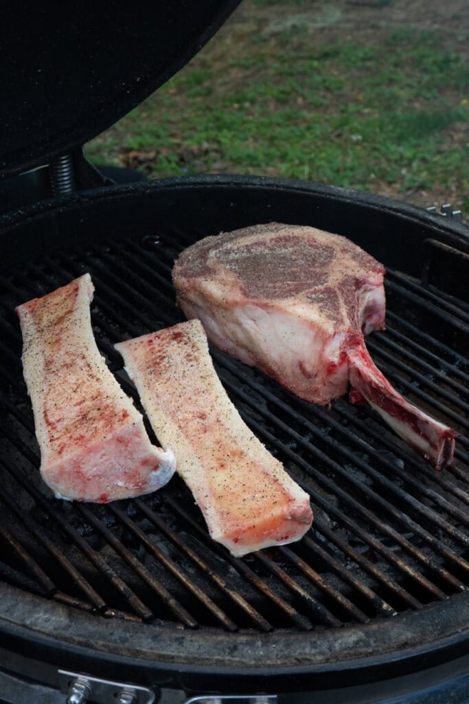 Steak and bone marrow boats on the smoker.