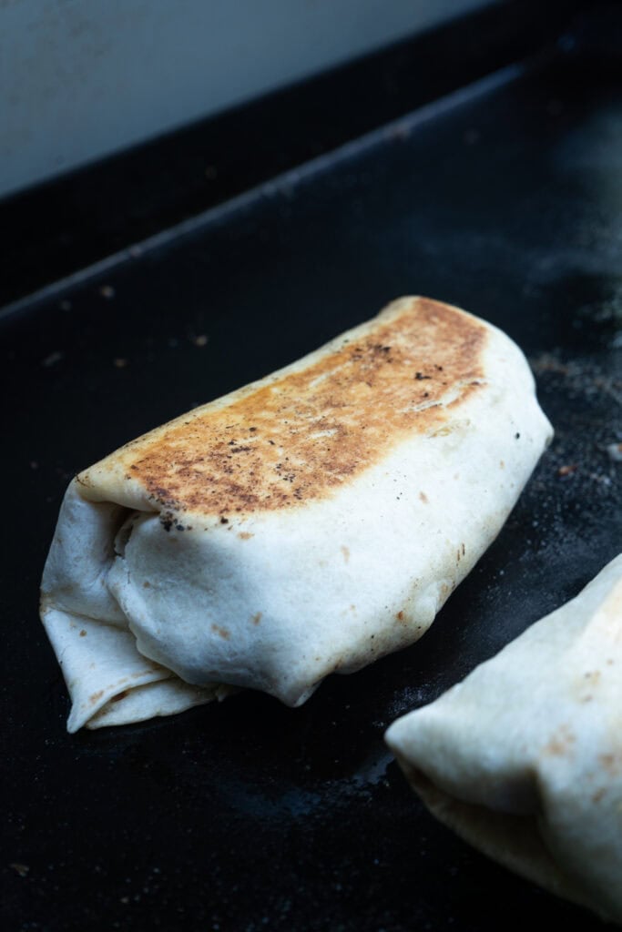 Steak and Egg Breakfast Burrito on a Griddle.