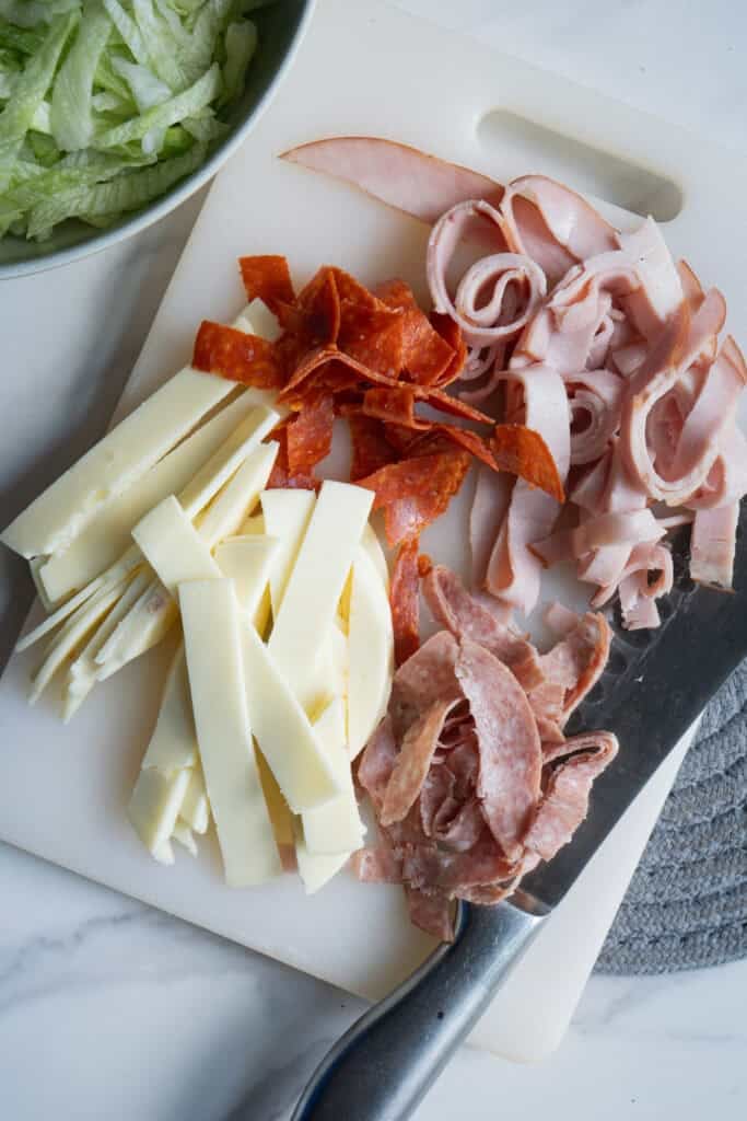 Chopped deli meats on a cutting board.