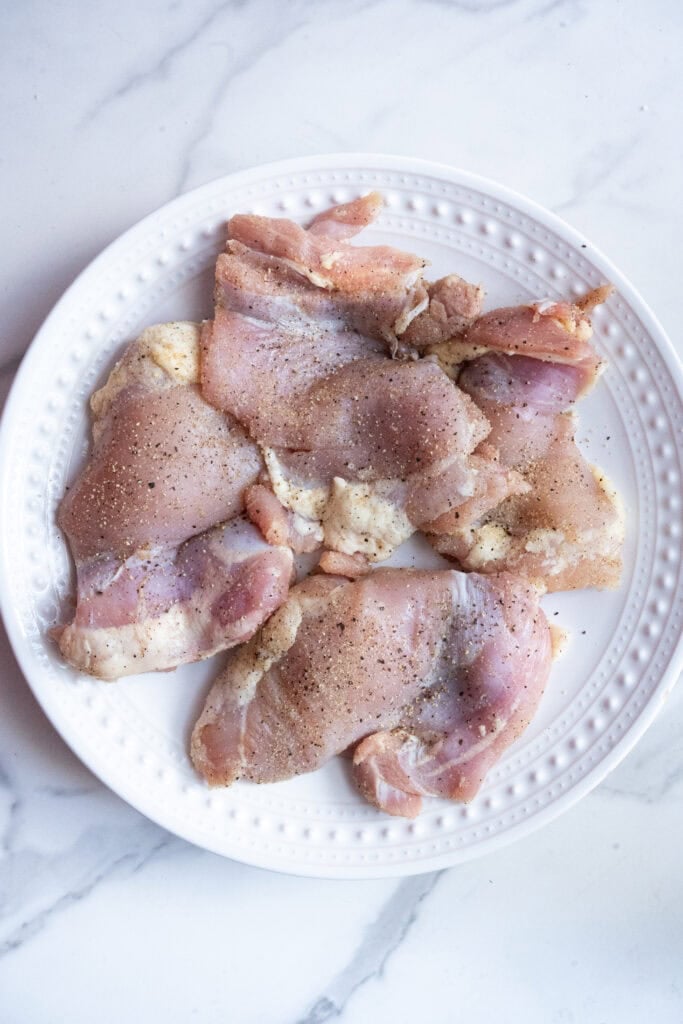 Chicken thighs seasoned with salt, pepper, garlic powder.