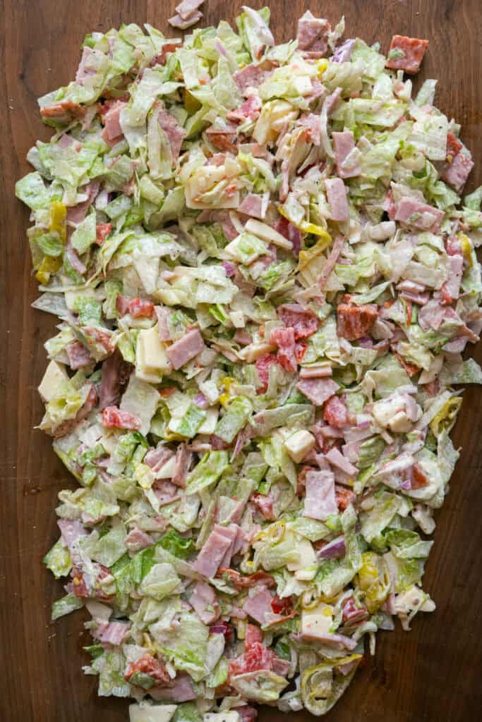 Chopped Italian Sandwich ingredients mixed on a cutting board.