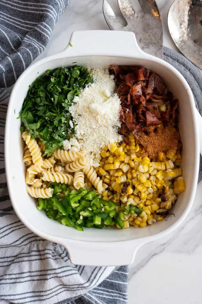 Mexican Street Corn Pasta Salad ingredients in a bowl.
