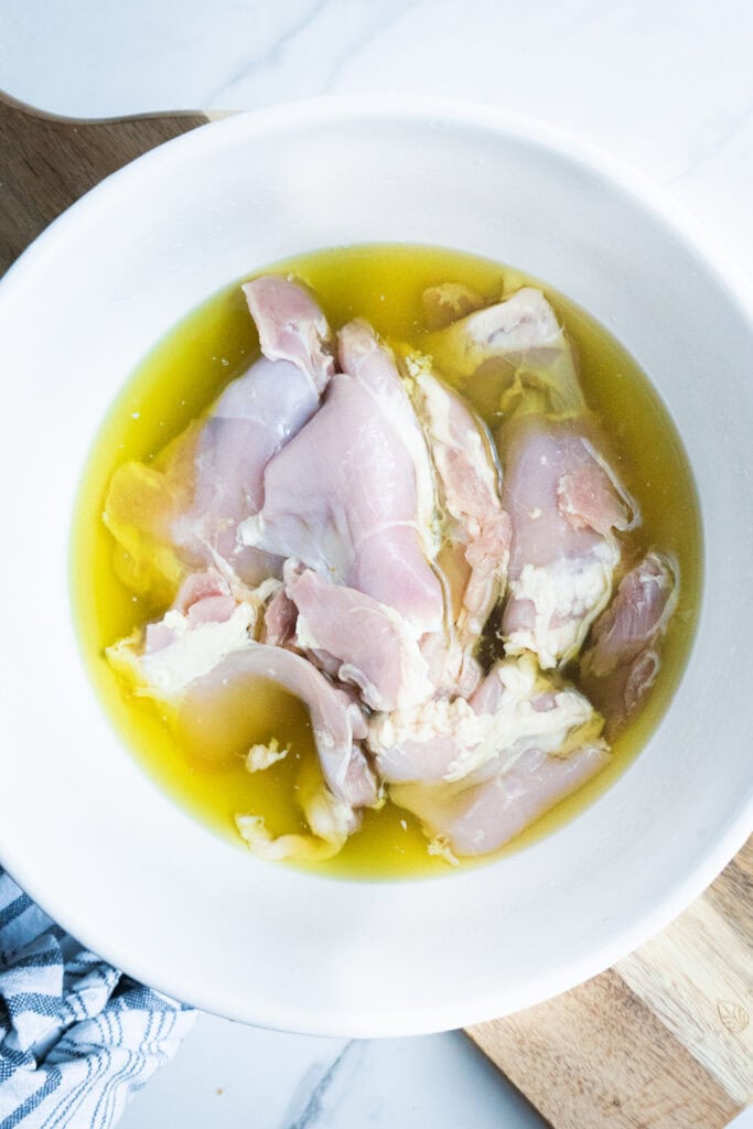 chicken thighs brining in pickle juice.