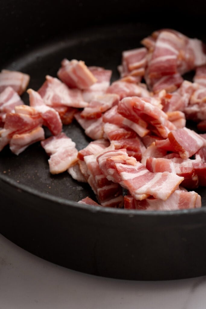 bacon cooking in a skillet.