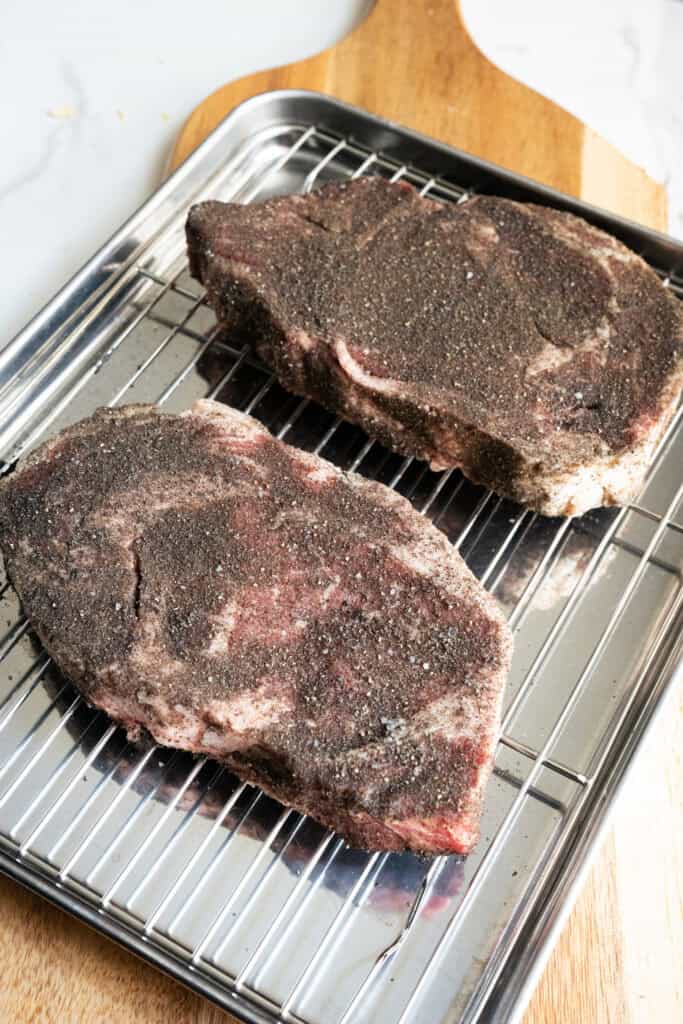 Ribeye steaks seasoned with steak seasoning.