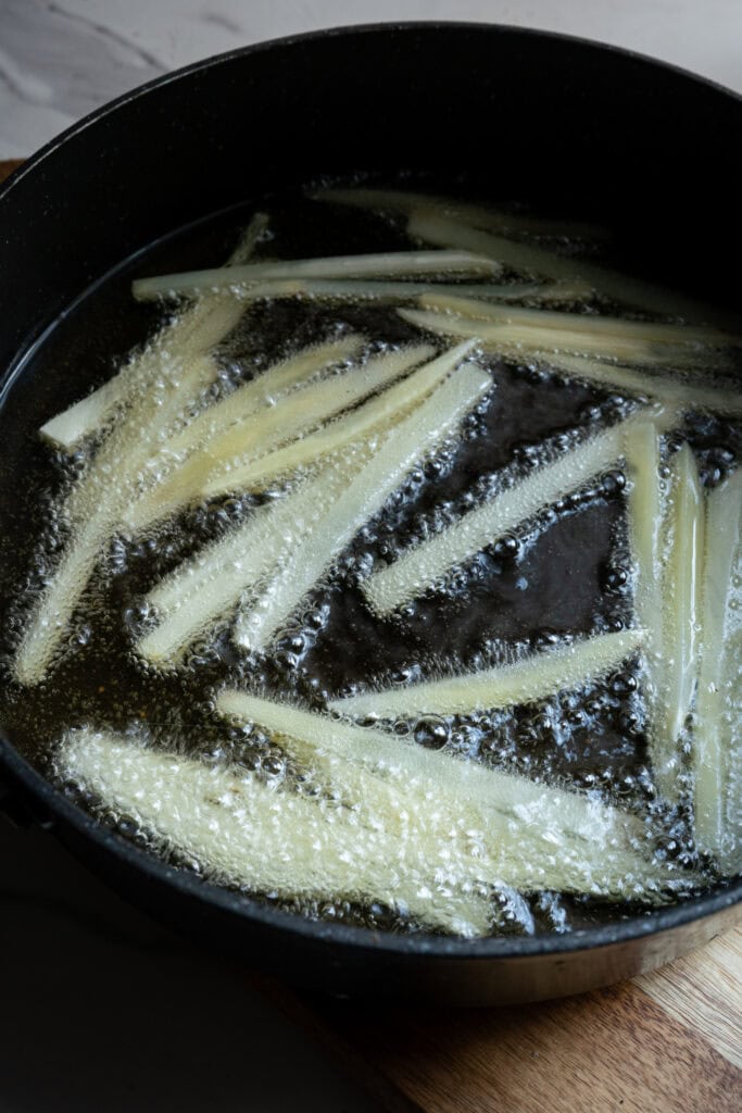 Fries frying in hot oil.