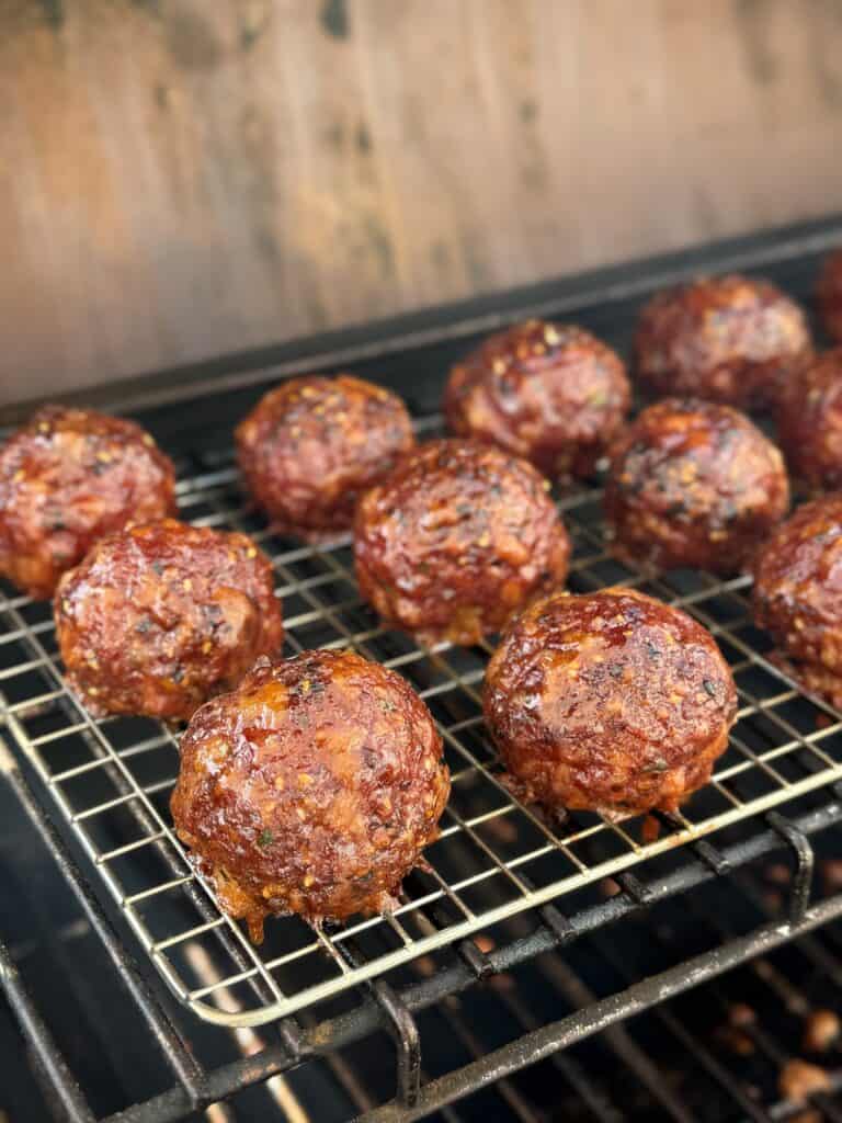 jalapeno popper smoked meatballs on the smoker.
