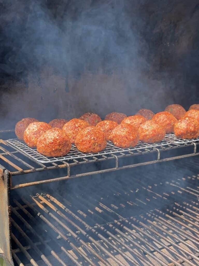 jalapeno popper smoked meatballs on the smoker.