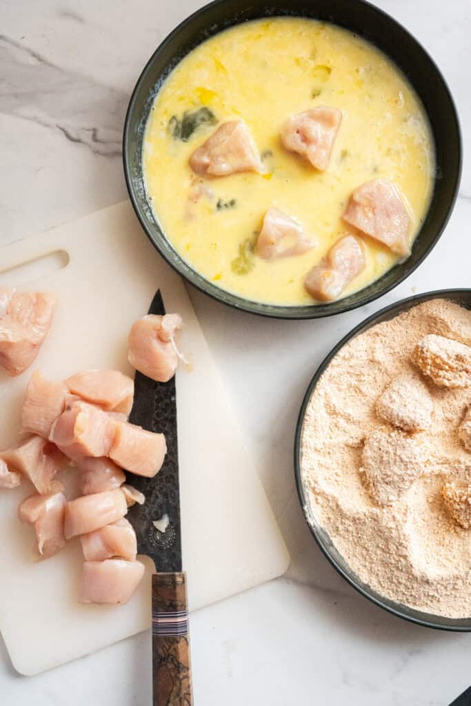 Chicken cubed and in an egg wash.