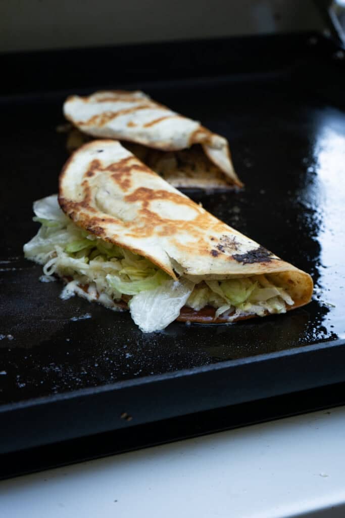 Smash Burger Quesadilla on the griddle.