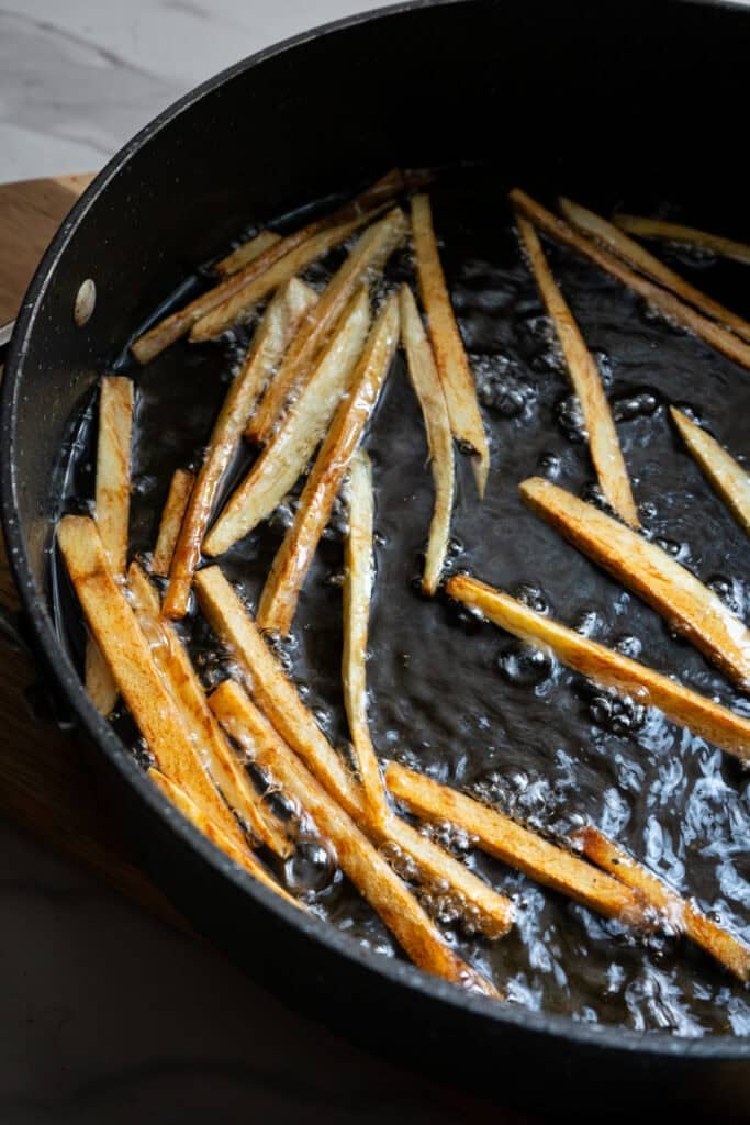 Fries cooking in hot oil.