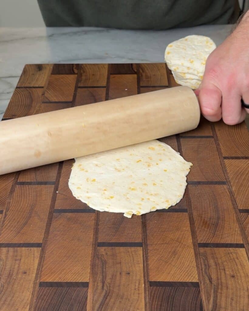 Rolling a biscuit flat.
