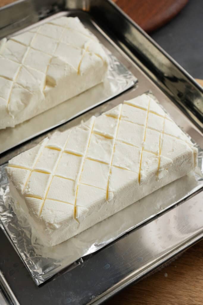 Cream cheese scored in a crosshatch pattern.