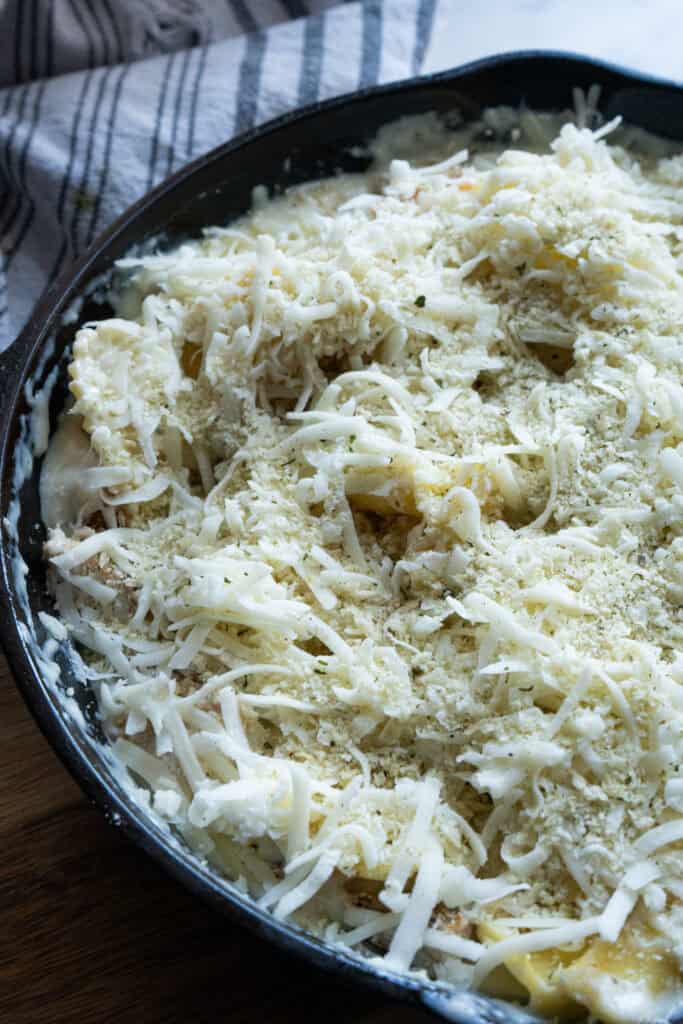 Grilled chicken alfredo casserole in a skillet.