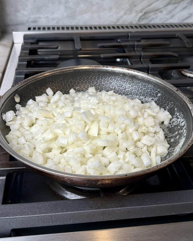 Onions cooking in a skillet.