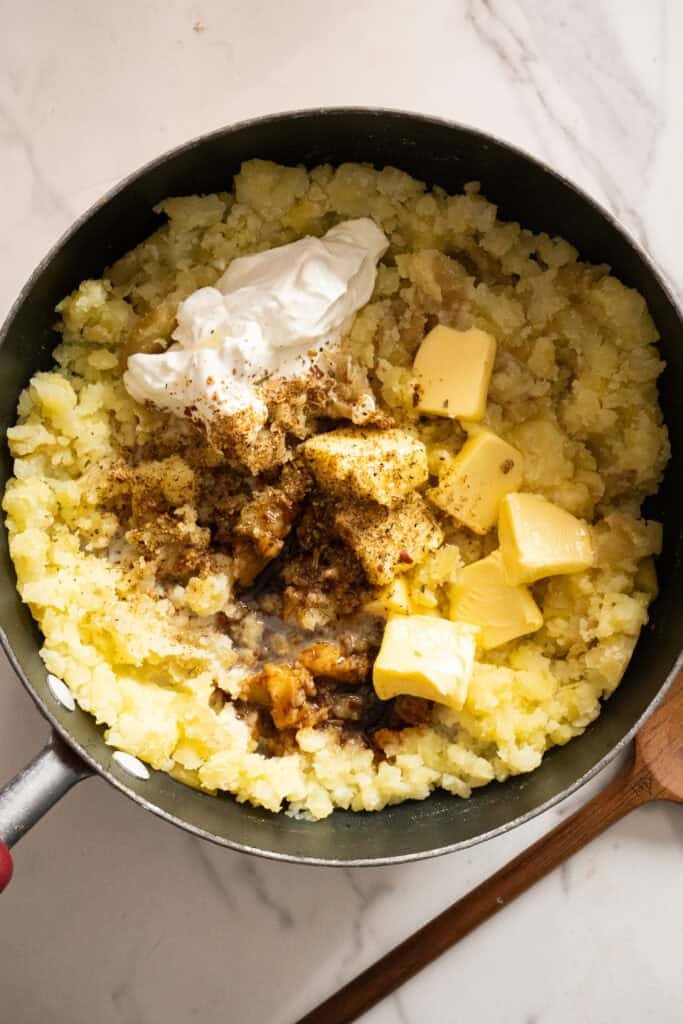 Ingredients for Mashed Potatoes in pan.