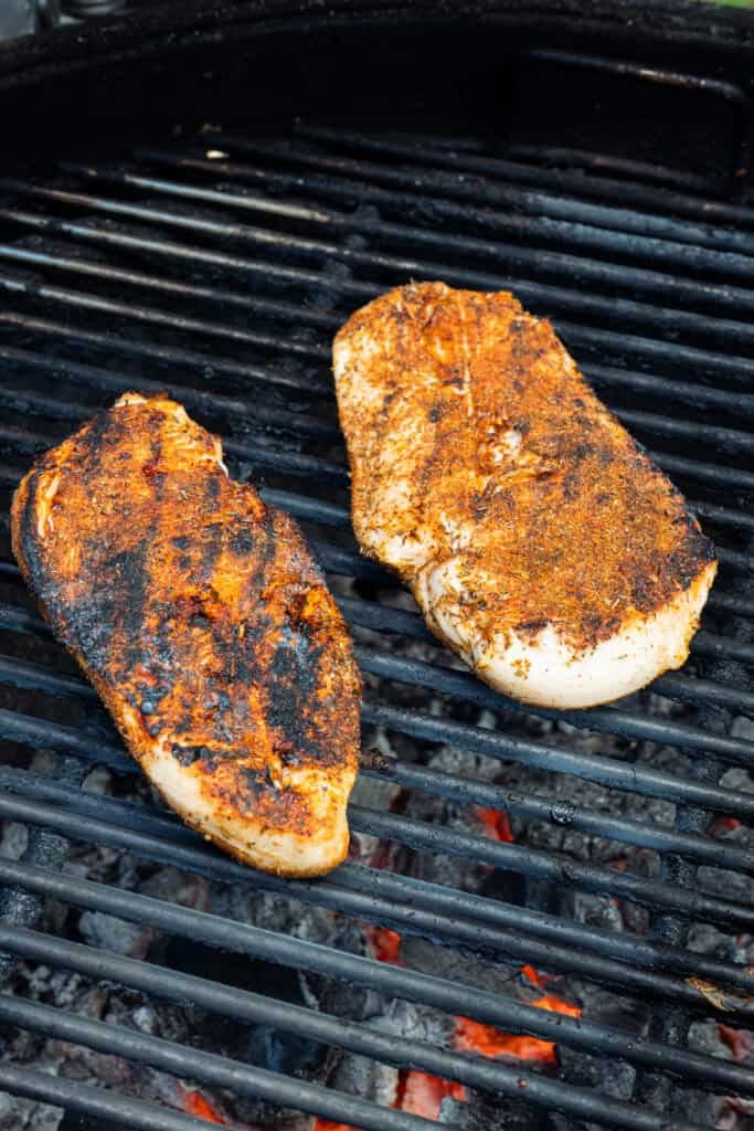 Chicken being cooked on a grill.