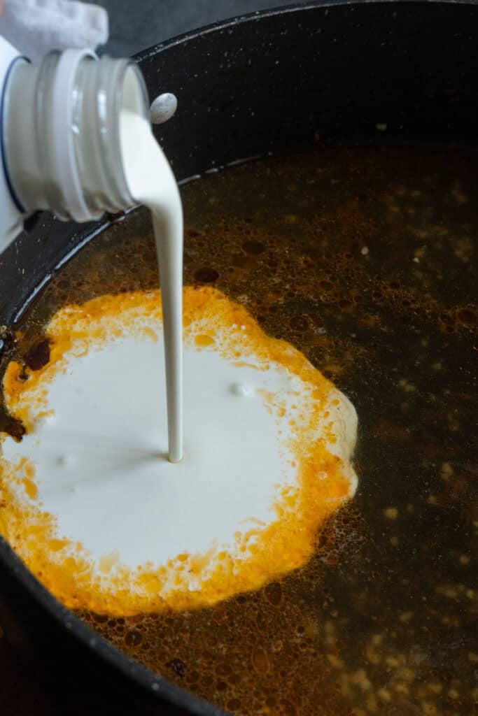 Pouring cream in pan.