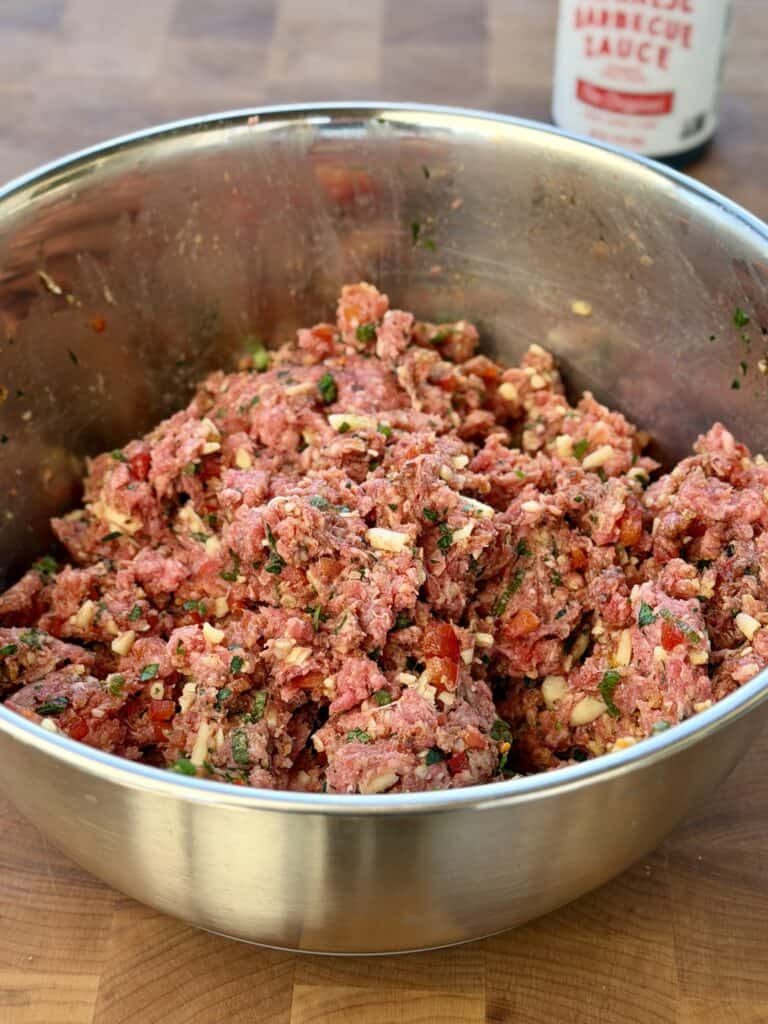 Mixing Burger together with ingredients.
