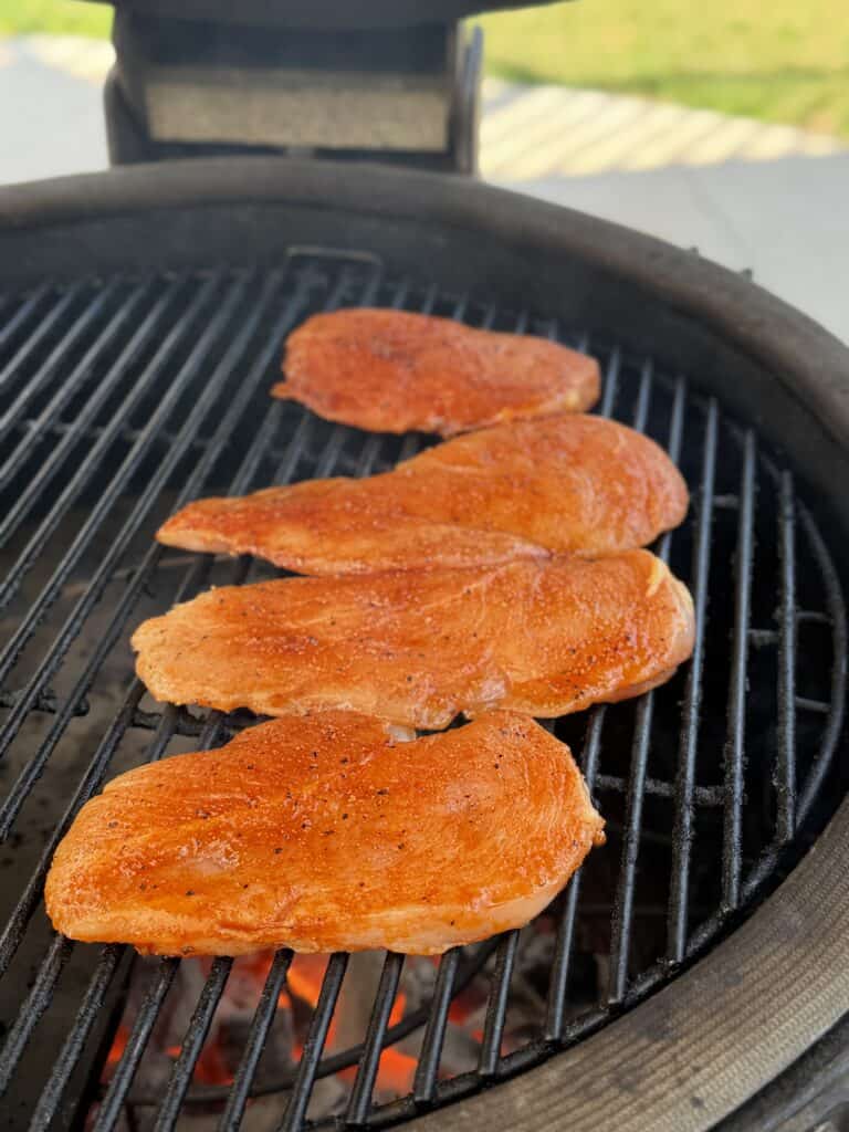 chicken being cooked on a grill.