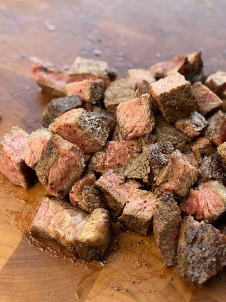 Steak cut into bite size pieces.
