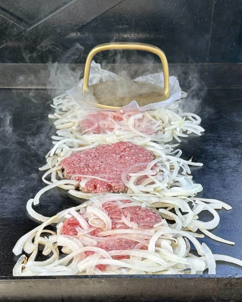 Smash onions on top of burger.