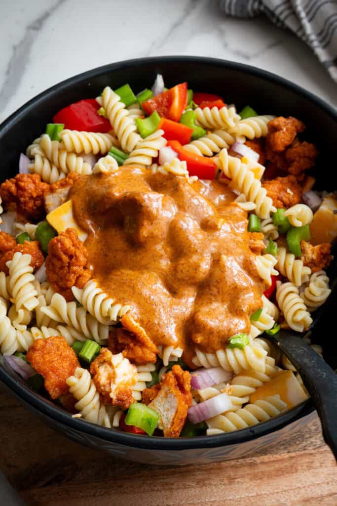 Sauce poured on ingredients in bowl.