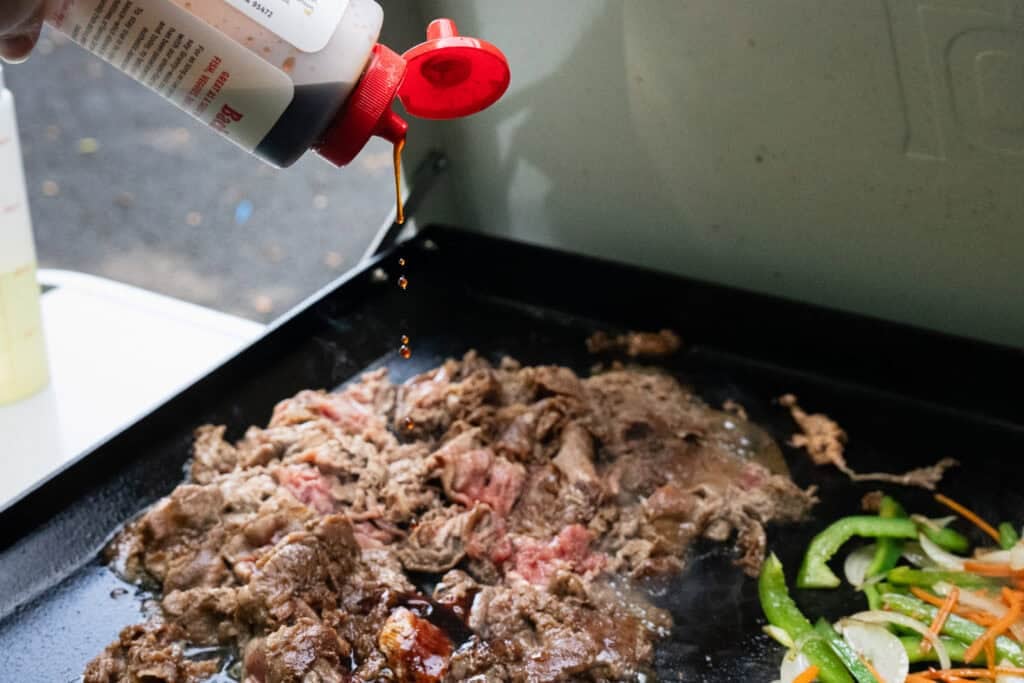 Meat on griddle cooking.