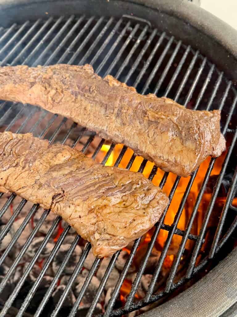 marinated skirt steak being grilled.