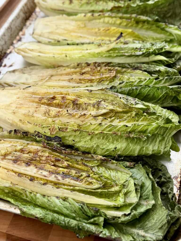 Grilled lettuce on a sheet pan.