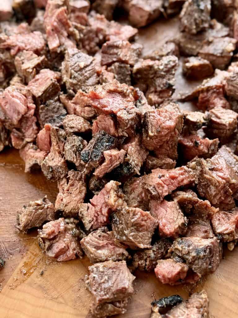 Steak cut up into bite size pieces.